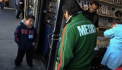 
              Mexican immigrant Roberto Garcia, center, and son Alan, left, look at wrist watches while shopping in Los Angeles, Monday, Jan. 28, 2013. Seeking swift action on immigration, President 